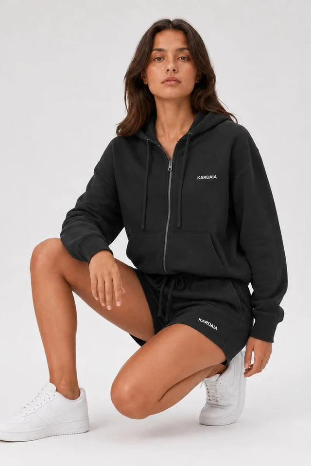 Sweat à capuche femme noir en coton bio porté accroupie