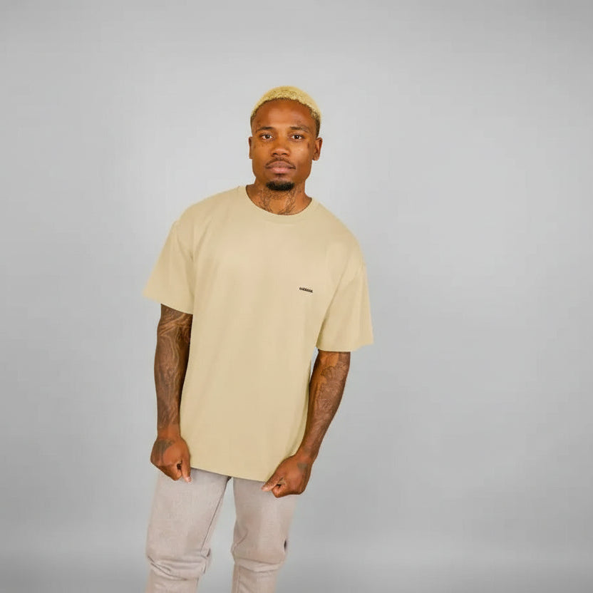 t-shirt oversize sable KARDAIA porté par un homme debout devant fond beige